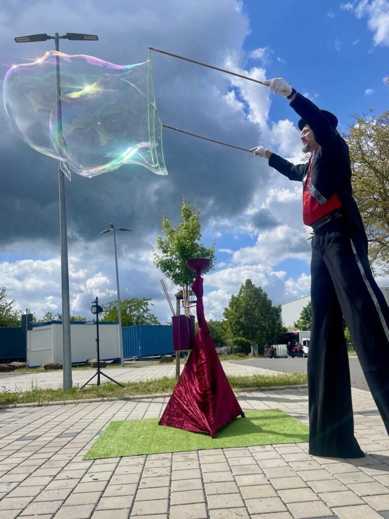 Perujo auf Stelzen macht Riesenseifenblase beim Sommerfest – Walkact-Show für Events
